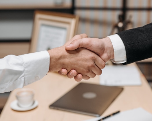 two hands engaged in a handshake indicating an agreement was made