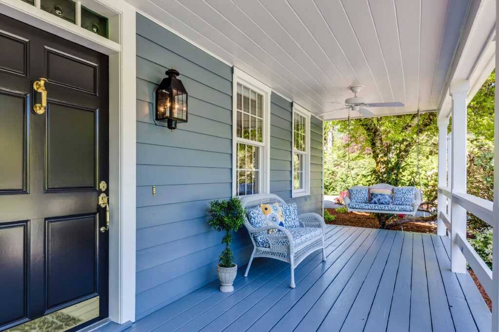 view of a front porch with a porch swing